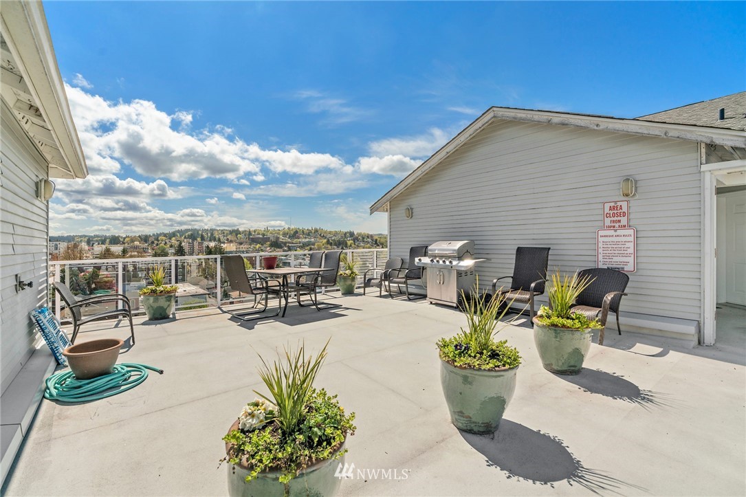 2522 Rucker Avenue, Unit 407 Everett, WA 98201 - Photo 23 of 30 a view of a terrace with chairs and potted plants