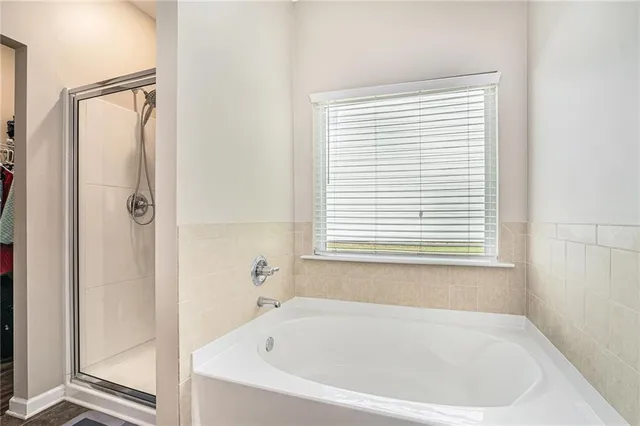 a white bath tub sitting next to a window