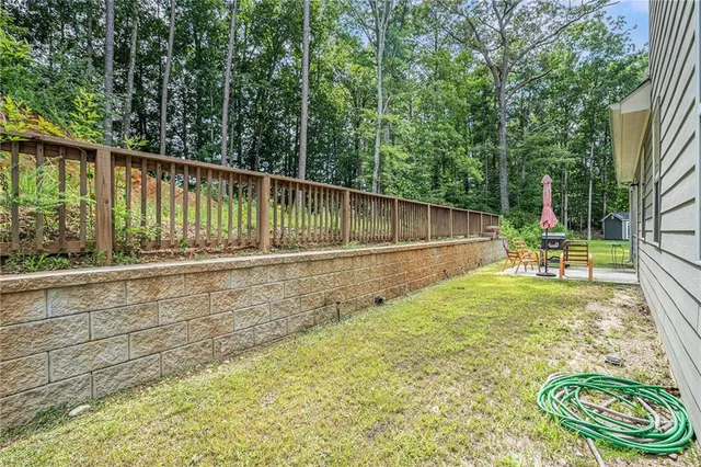 a view of a backyard with a small pool and sitting area