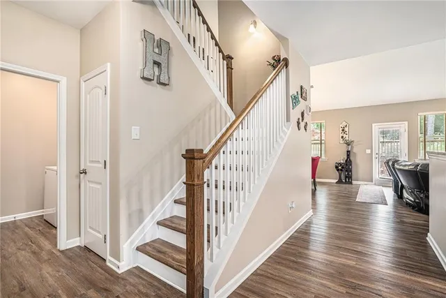 a view of entryway and hall with wooden floor