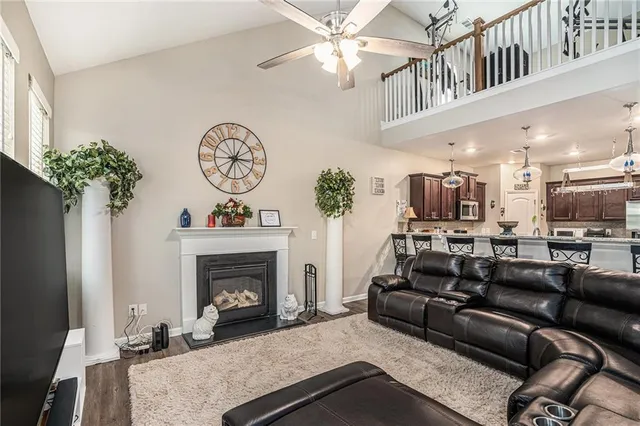 a living room with furniture a fireplace and a chandelier