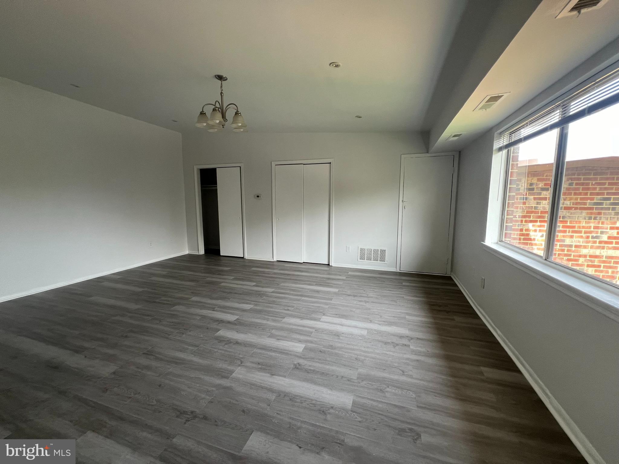 7521 Riverdale Road, Unit 1979 New Carrollton, MD 20784 - Photo 3 of 8 wooden floor in an empty room with a window