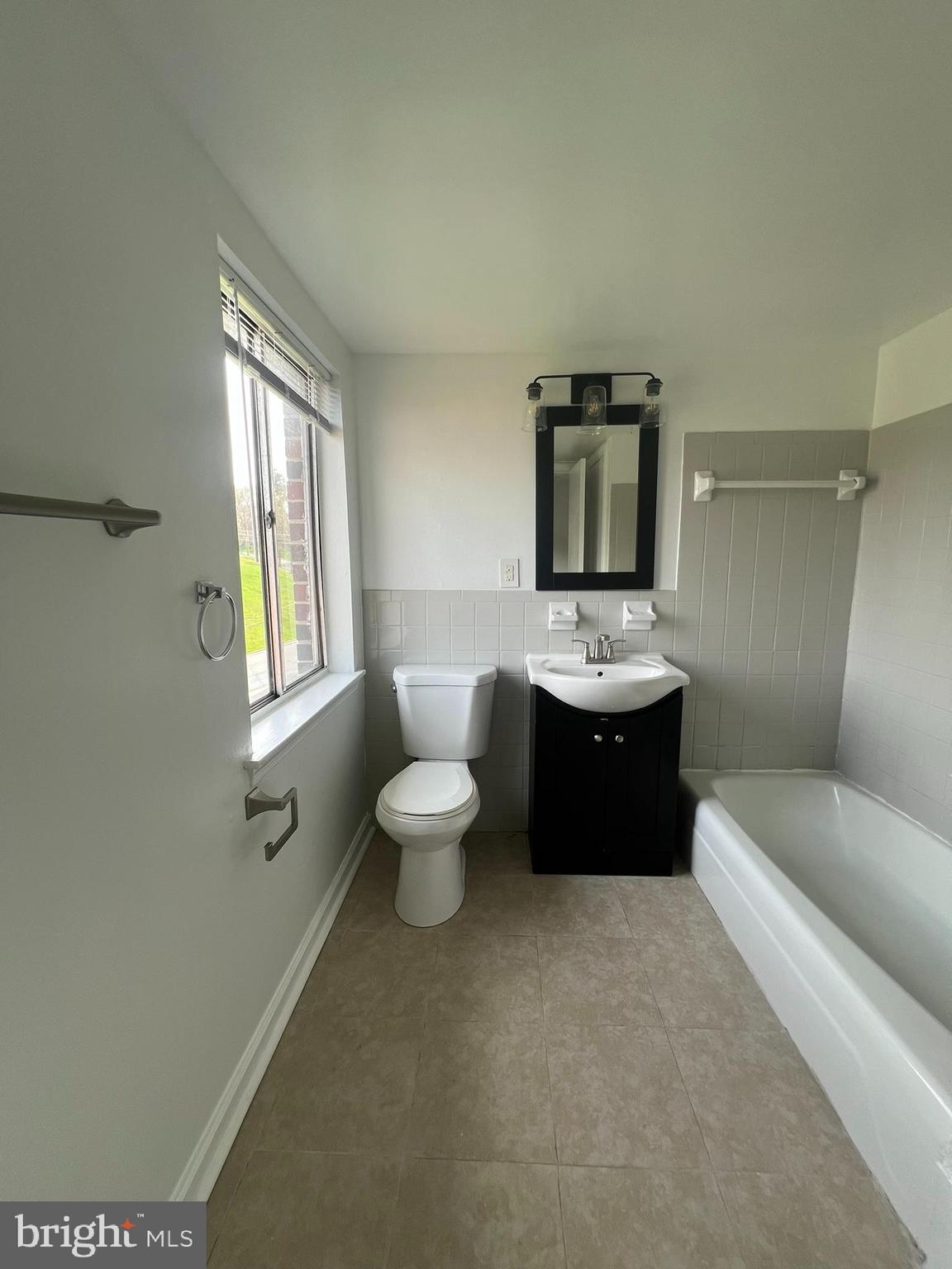 7521 Riverdale Road, Unit 1979 New Carrollton, MD 20784 - Photo 4 of 8 a bathroom with a toilet sink and mirror