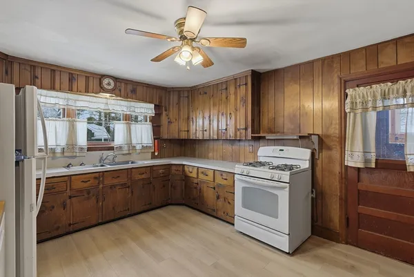 a kitchen with a sink cabinets and window