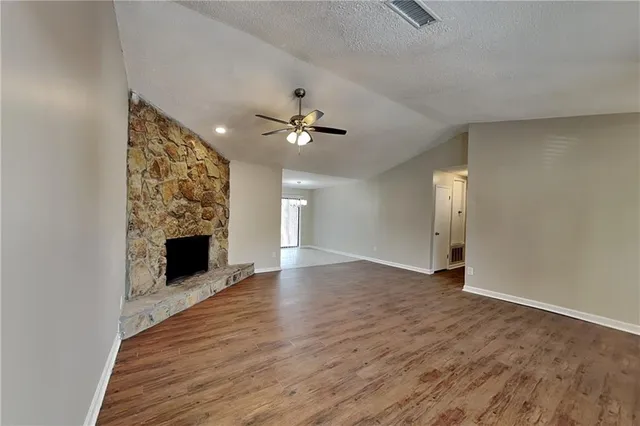 wooden floor in an empty room with a fireplace