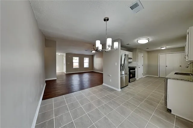 a view of a livingroom with furniture and chandelier
