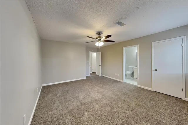 a view of an empty room with a ceiling fan