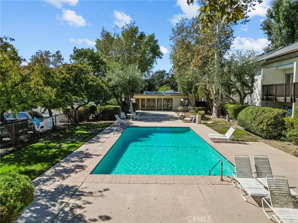 swimming pool view with a seating space and a garden view