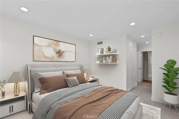 a bedroom with furniture and a painting on the wall