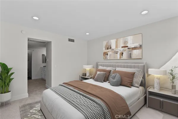 a bedroom with a bed and a potted plant