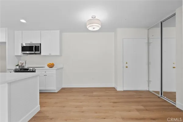 a kitchen with kitchen island a sink stainless steel appliances and cabinets