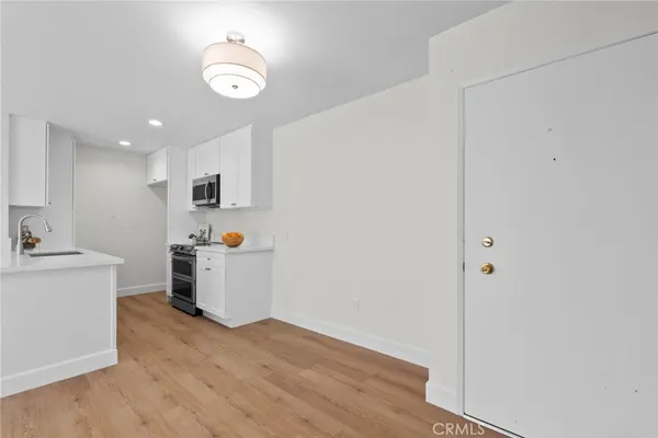 a view of a kitchen with wooden floor