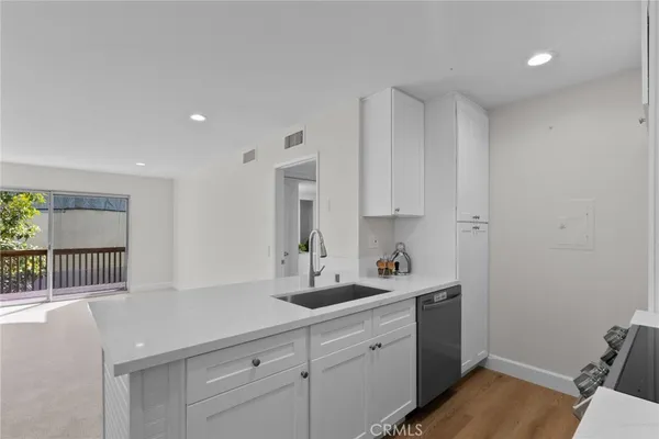 a kitchen with a sink cabinets and a window