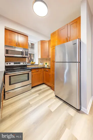 a kitchen with a refrigerator and a stove