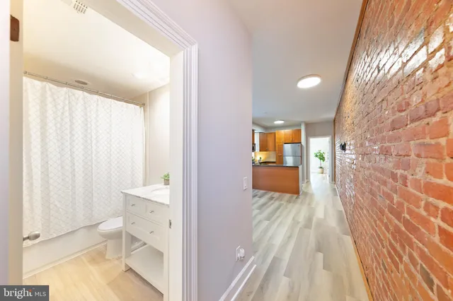 a bathroom with a granite countertop sink toilet and a mirror