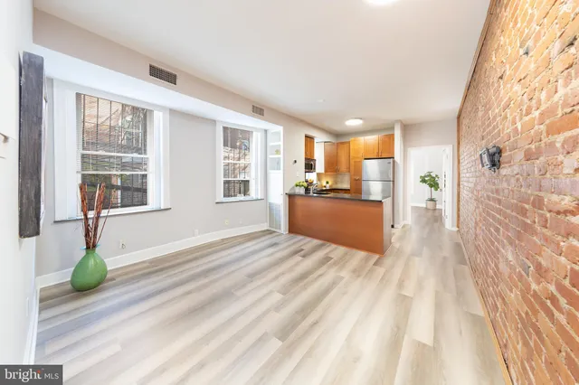 a view of an entryway with wooden floor and windows