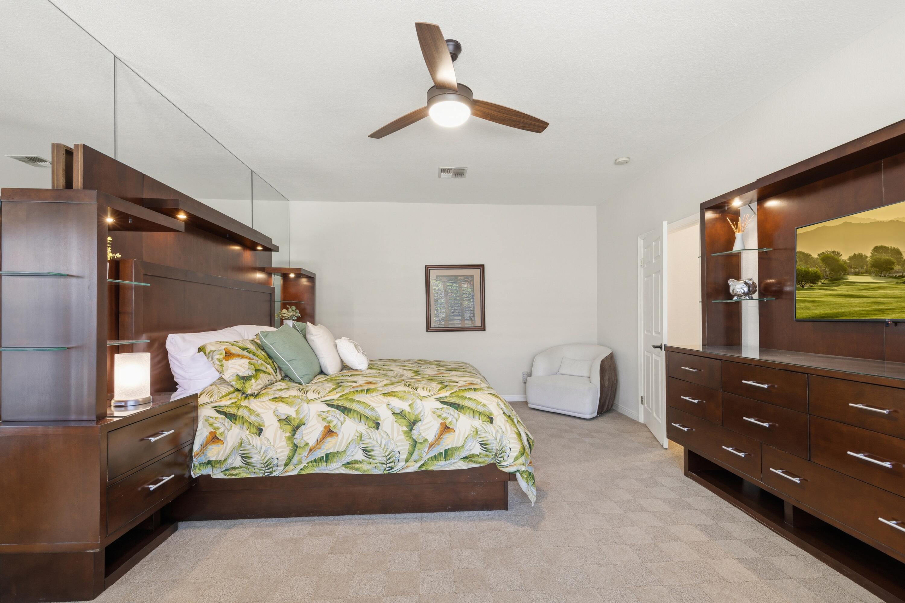 39 Augusta Drive Rancho Mirage, CA 92270 - Photo 27 of 53 a bedroom with a bed and a flat tv screen on dresser