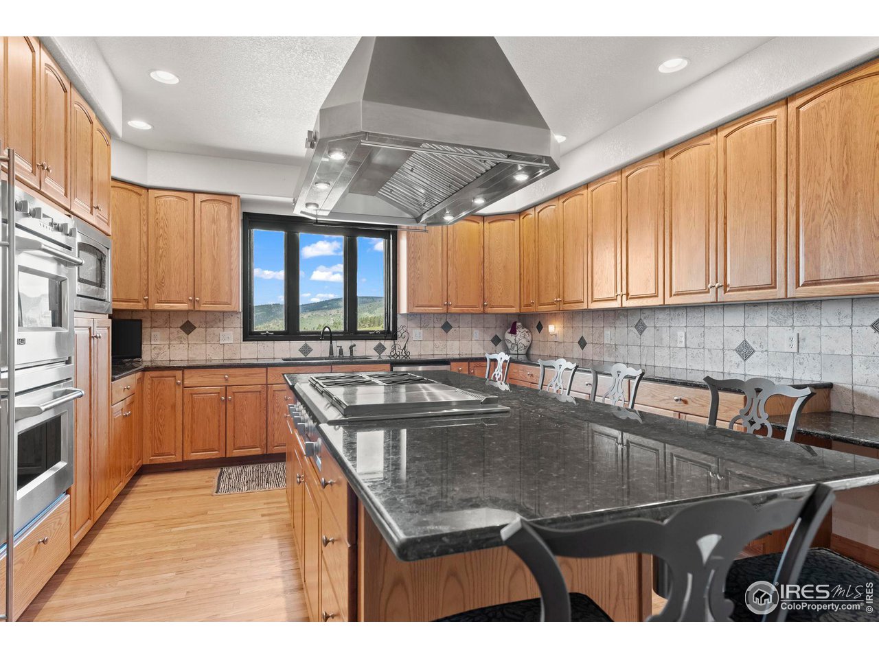 603 Indian Lookout Road Lyons, CO 80540 - Photo 11 of 39 a kitchen with a sink a stove cabinets and a window