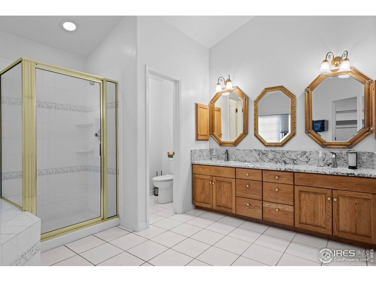 603 Indian Lookout Road Lyons, CO 80540 - Photo 24 of 39 a bathroom with a granite countertop sink and a mirror
