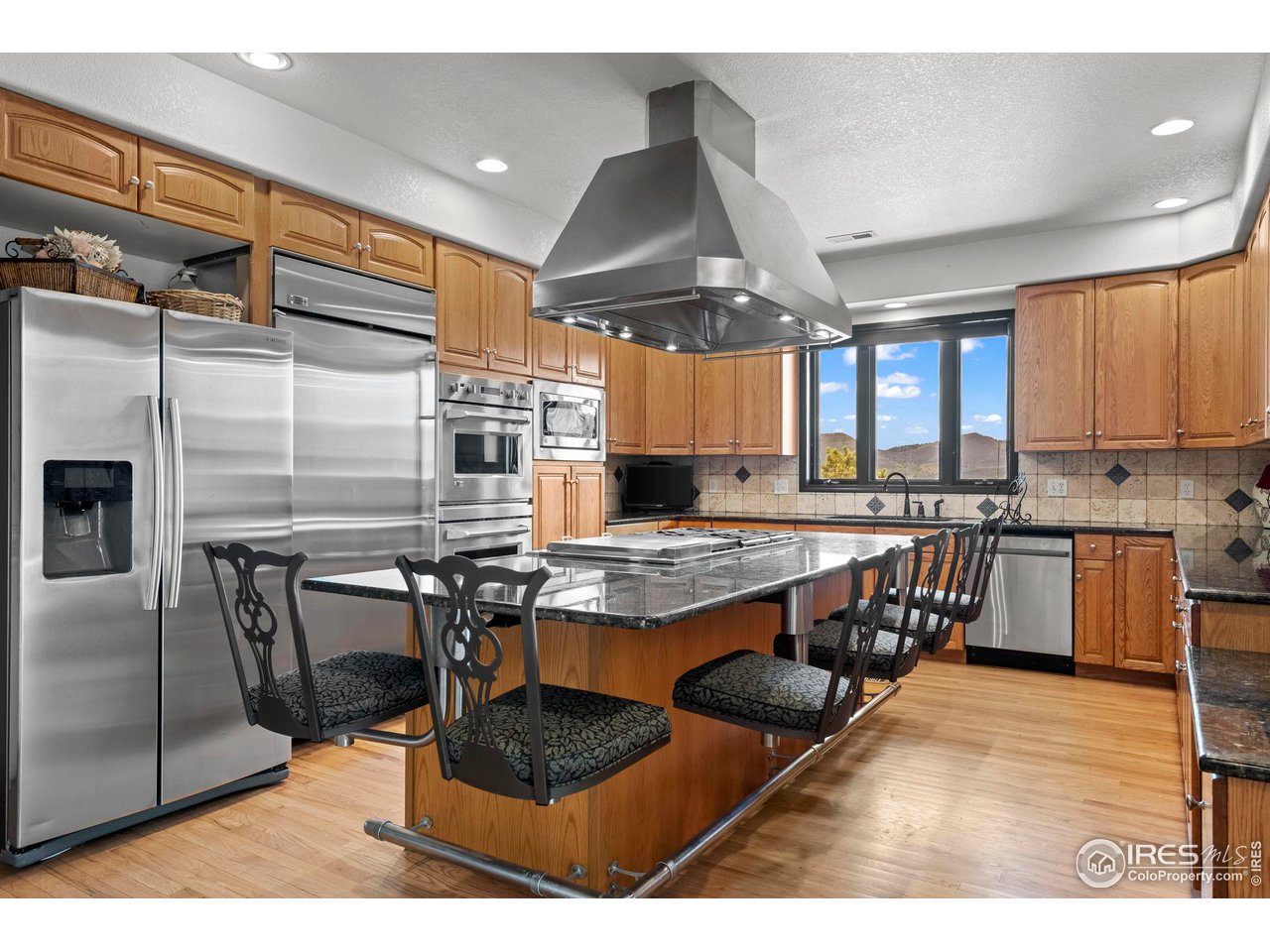 603 Indian Lookout Road Lyons, CO 80540 - Photo 10 of 39 a kitchen with stainless steel appliances granite countertop a stove and a refrigerator
