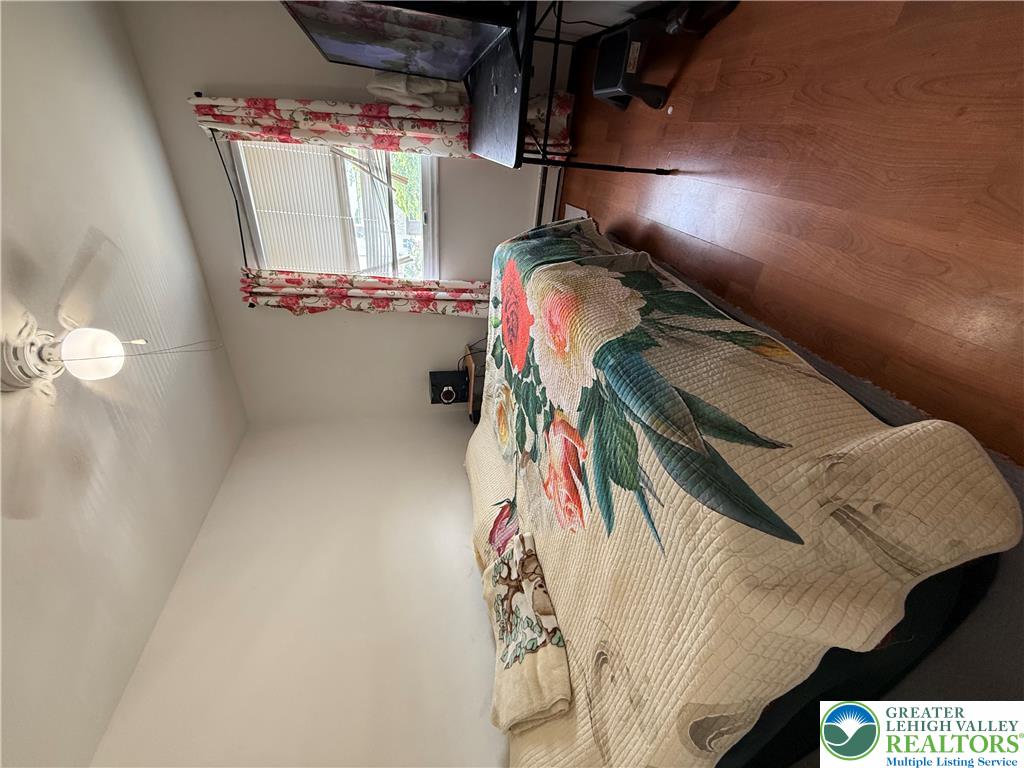 1150 Ridge Avenue Allentown, PA 18102 - Photo 7 of 14 Well-lit sleeping quarters with a window, hard-surface flooring, and a ceiling fan for comfort.