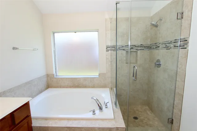 a white bath tub sitting next to a shower