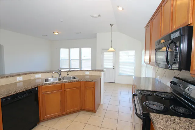 a kitchen with a sink stove and cabinets