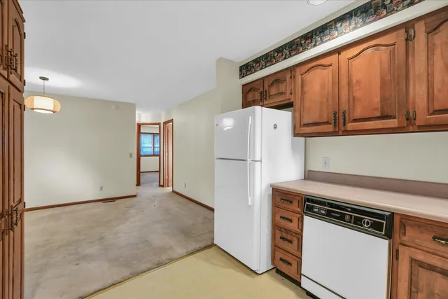 a kitchen with a refrigerator and a stove