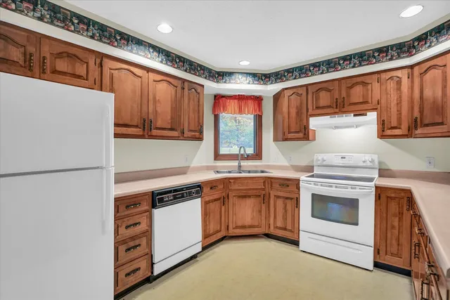 a kitchen with stainless steel appliances granite countertop a stove and a refrigerator