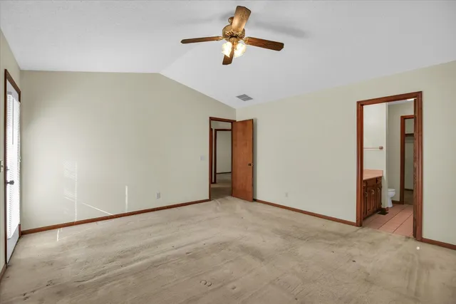 a view of empty room with ceiling fan