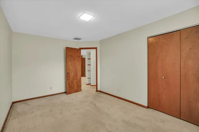 an empty room with closet area