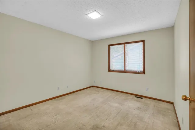 an empty room with a empty space and windows