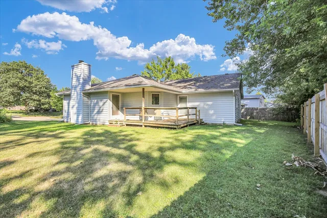 a front view of a house with a garden and plants