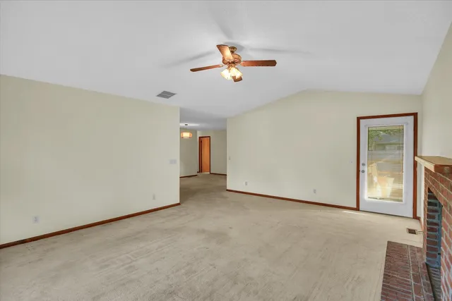 a view of a livingroom with a ceiling fan and window