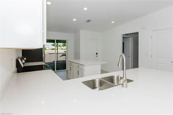 a kitchen with stainless steel appliances a sink and a refrigerator