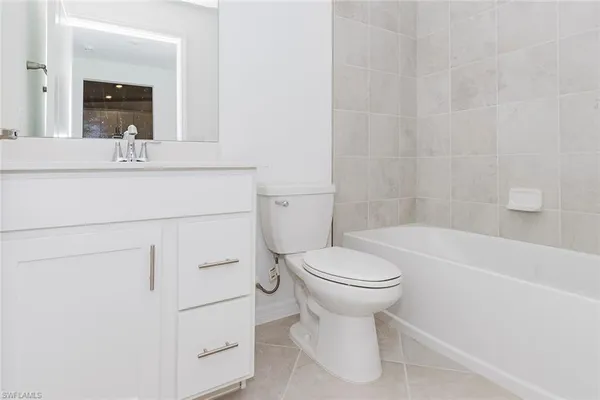a bathroom with a sink a toilet and bathtub