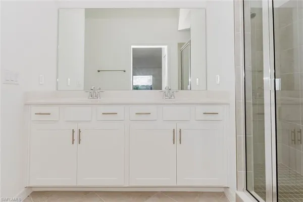 a bathroom with a shower sink and mirror