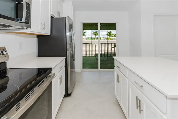 a kitchen with a refrigerator and a stove