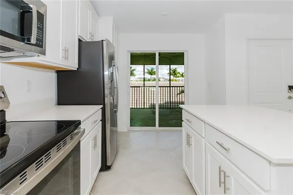 a kitchen with a refrigerator and a sink
