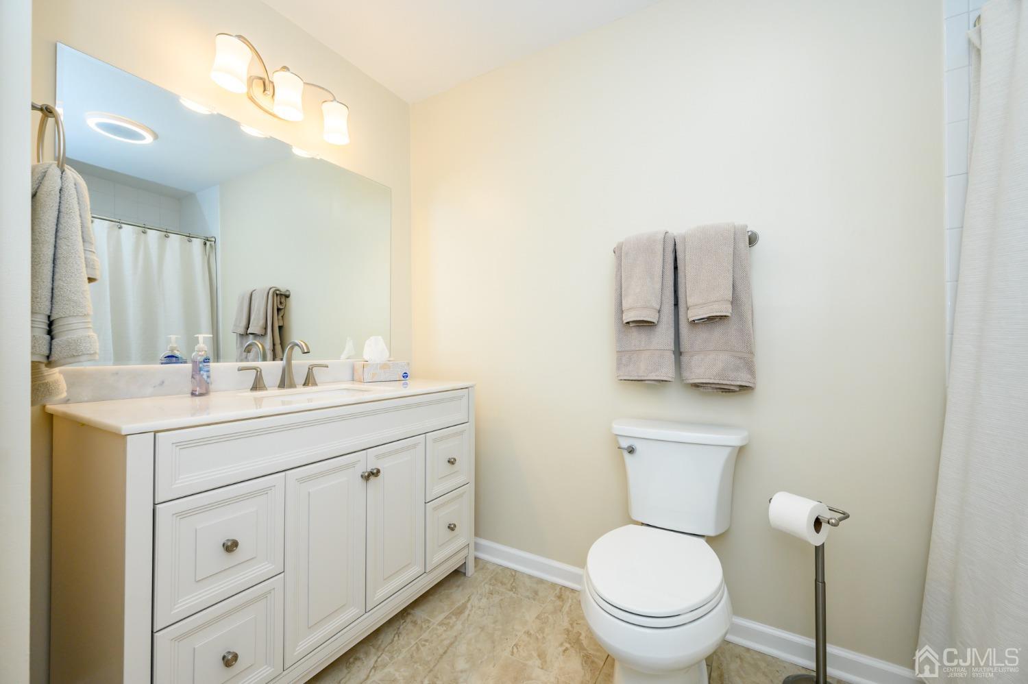 40 Fairfield Road Princeton, NJ 08540 - Photo 24 of 46 a bathroom with a toilet a sink a mirror and vanity