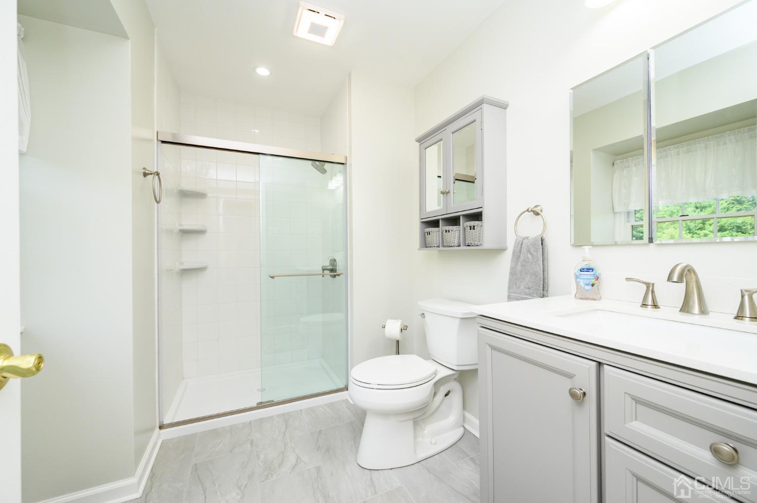 40 Fairfield Road Princeton, NJ 08540 - Photo 37 of 46 a bathroom with a sink toilet a mirror and shower
