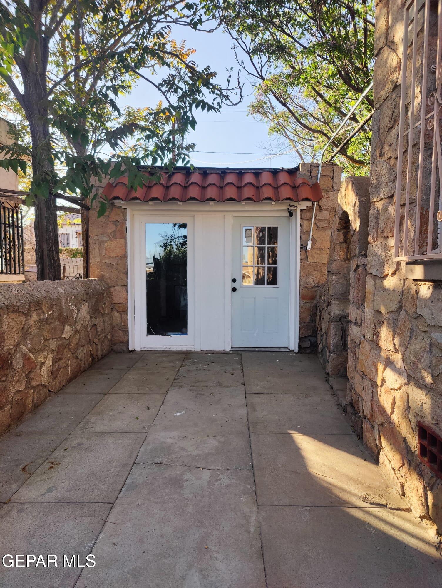 a view of a house with a tree and plants