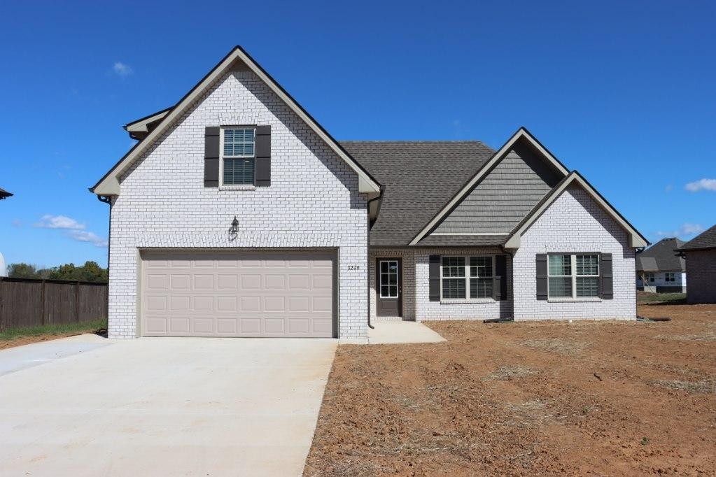 3249 Volta Road Christiana, TN 37037 - Photo 1 of 1 a front view of a house with a yard and garage