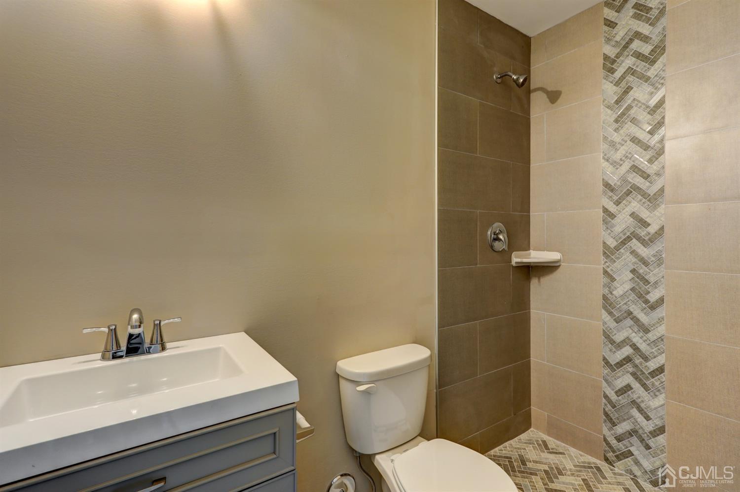 14 Richmond Road Edison, NJ 08817 - Photo 11 of 17 a white toilet sitting next to a bathroom sink