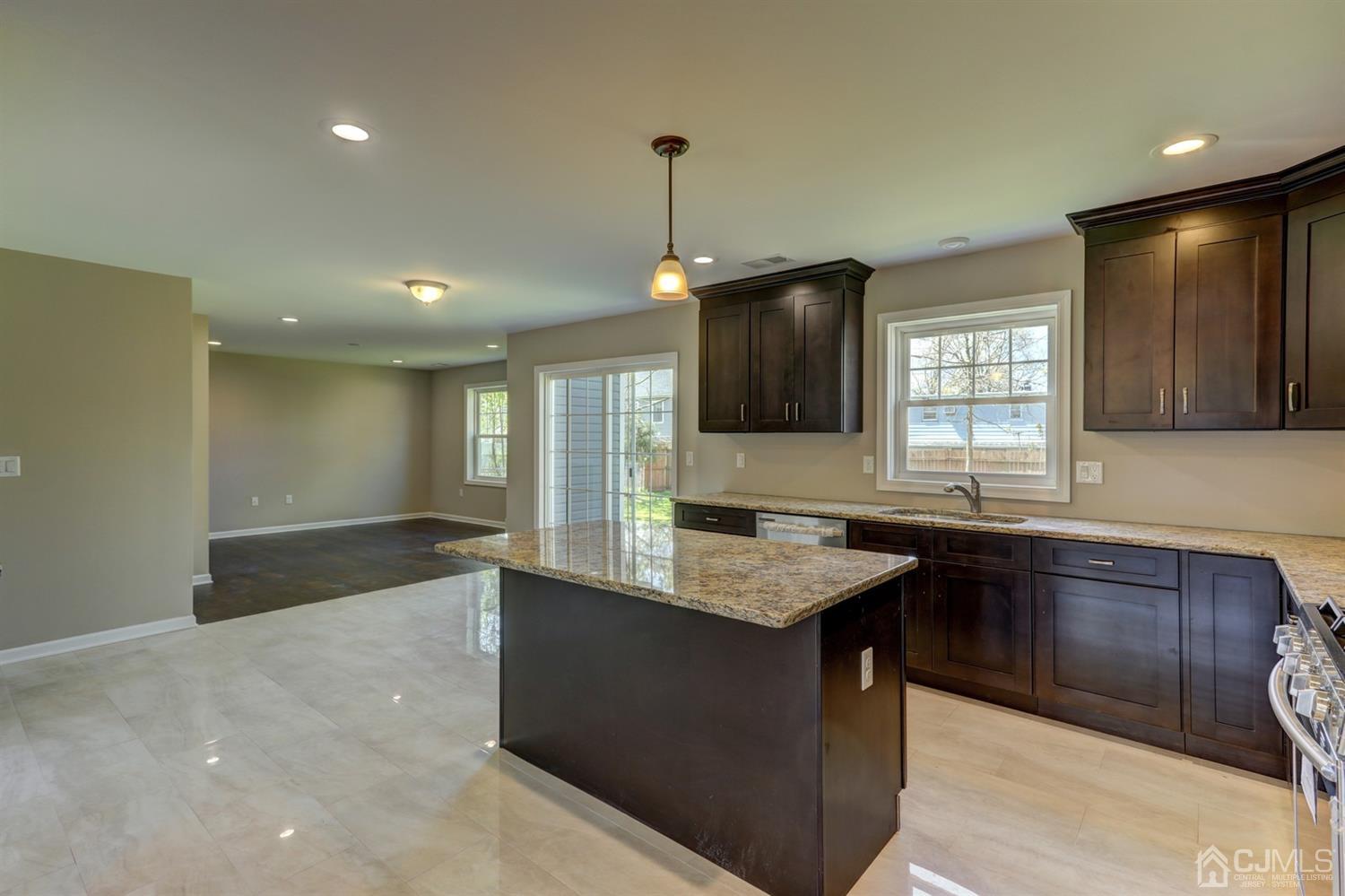 14 Richmond Road Edison, NJ 08817 - Photo 5 of 17 a kitchen with kitchen island granite countertop a sink counter space and a window