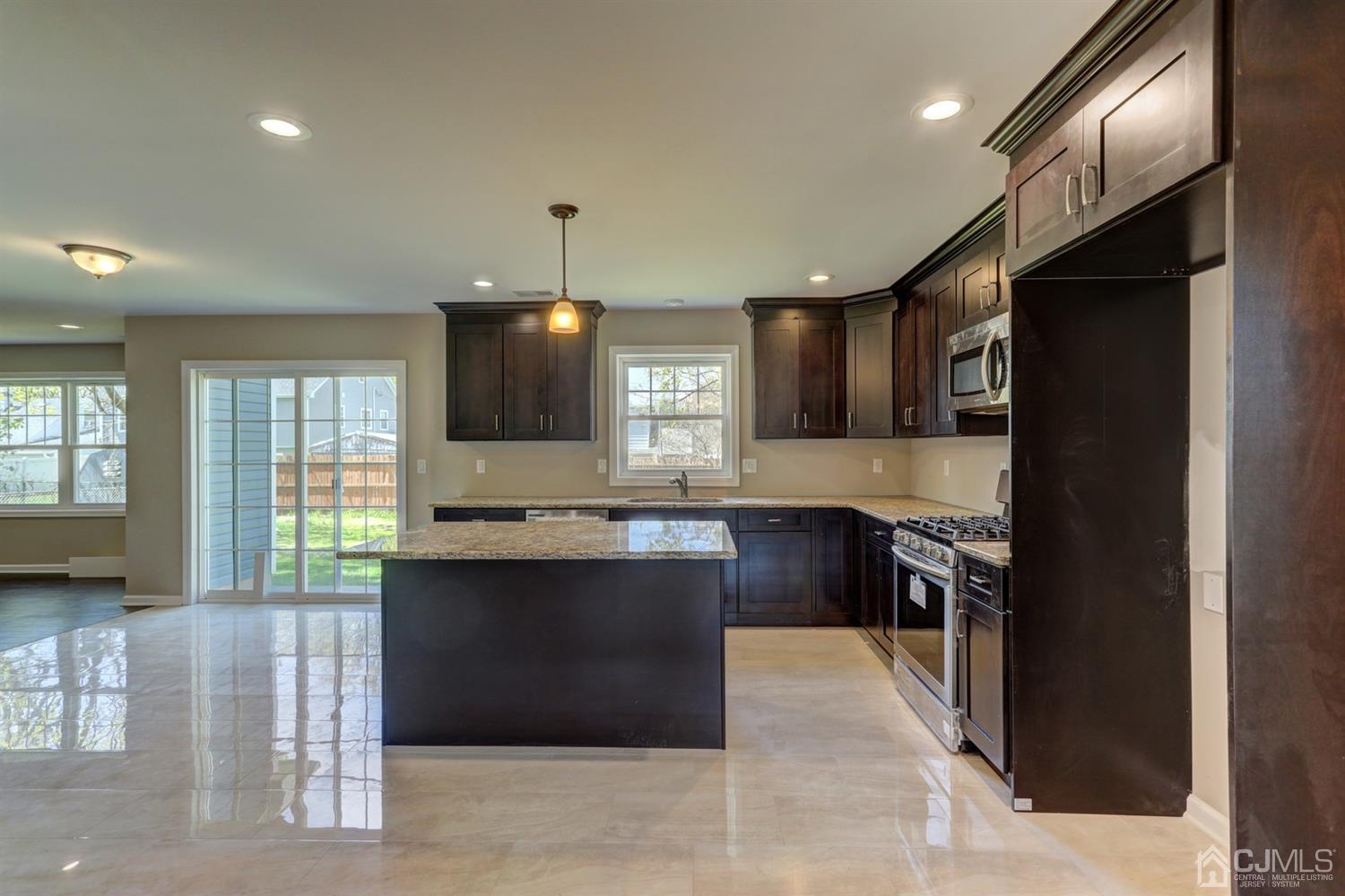 14 Richmond Road Edison, NJ 08817 - Photo 6 of 17 a kitchen with kitchen island a sink stainless steel appliances and cabinets