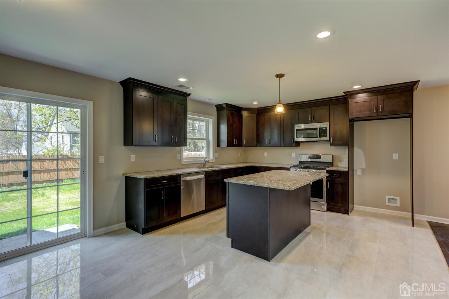 14 Richmond Road Edison, NJ 08817 - Photo 7 of 17 a modern kitchen with stainless steel appliances granite countertop a stove and a sink