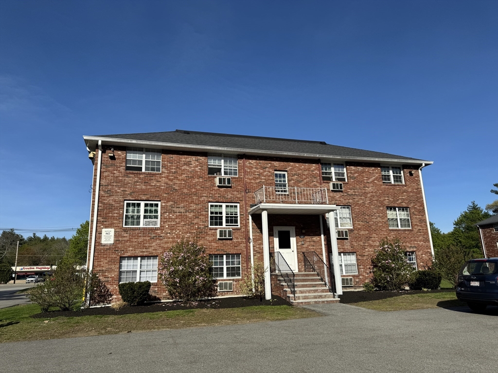 428 Great Road, Unit 6 Acton, MA 01720 - Photo 2 of 9 front view of house with a street