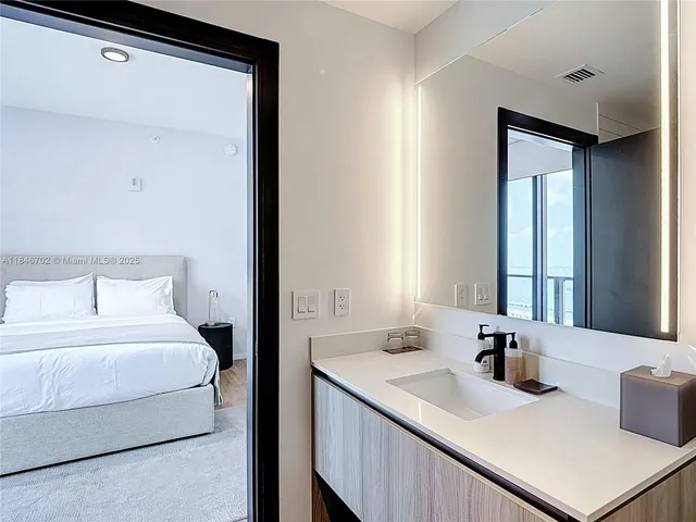 a en suite bathroom with a sink and a mirror