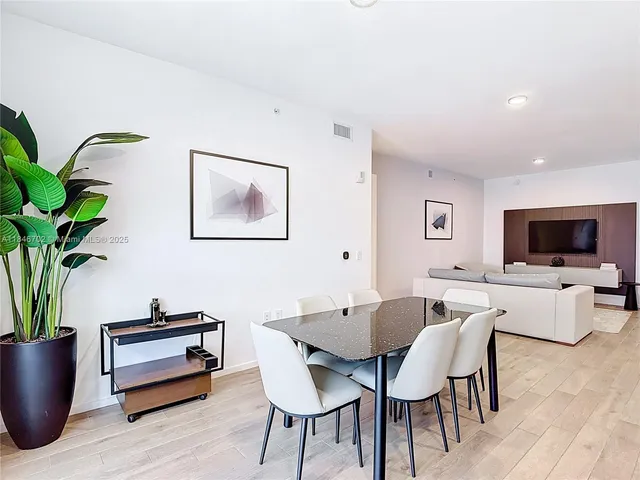 a dining room with furniture and wooden floor
